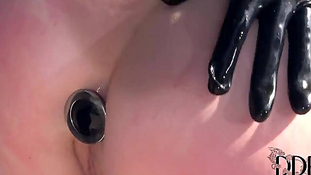 Nasty Latex Lucy with huge tits and big ass in kinky outfit and stripper shoes uses strap on to fuck naked brunette cutie Samantha Bentley in the ass in memorable bondage fantasy.