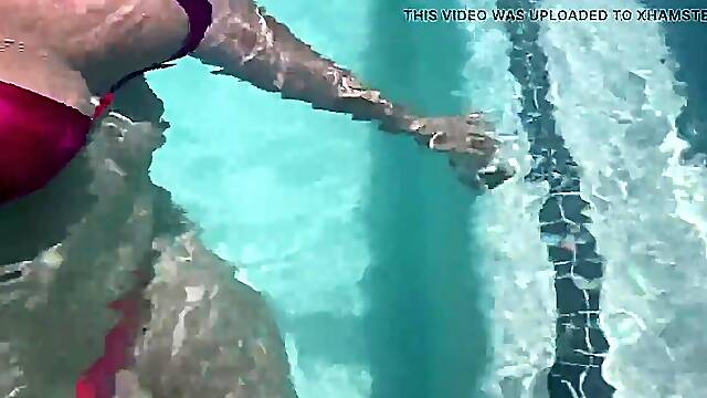 Sexy MILF shows off huge natural tits underwater