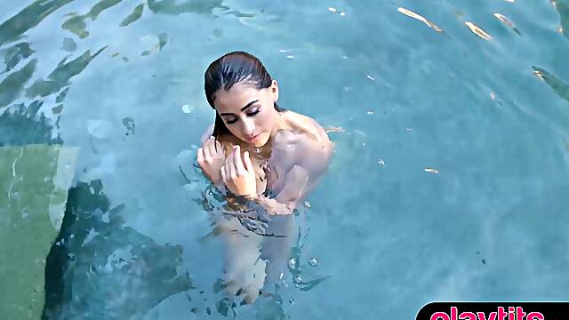 Curvy Latina babe strips swimsuit by the pool to expose big tits