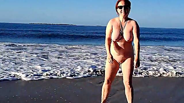 Real nudist Playing Stripped in the Ocean Waves
