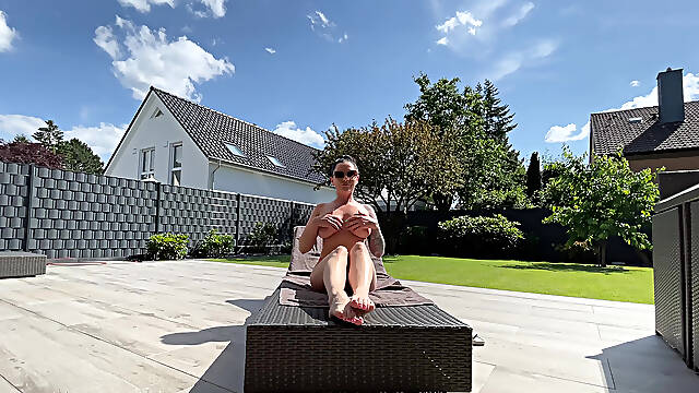 Hot milf pampers her sexy body on the terrace and oils herself
